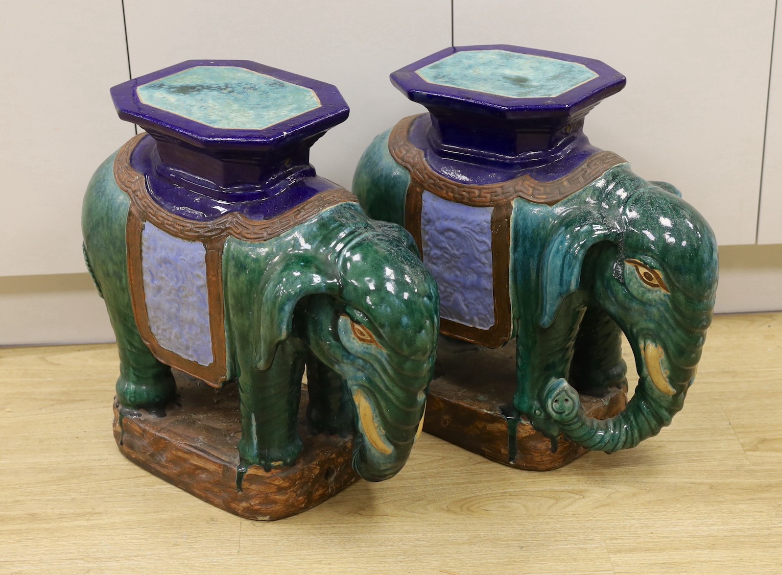 A pair of Chinese Shiwan type polychrome ‘elephant’ tables or stools, 57cm